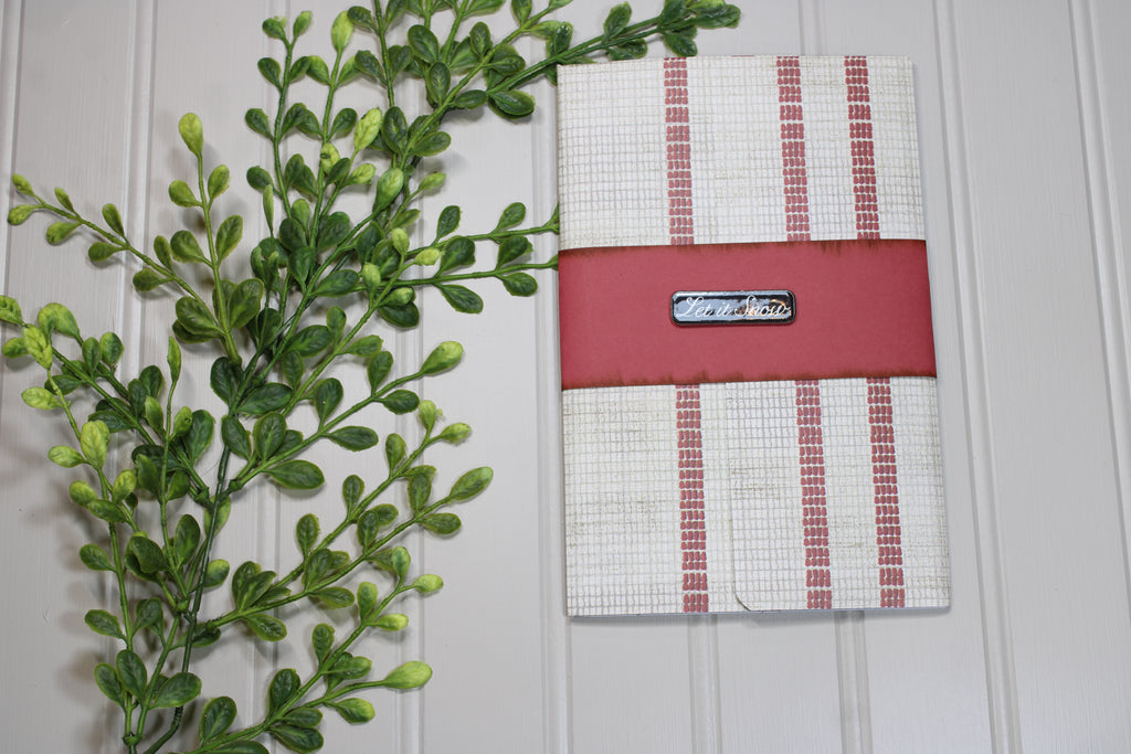 Red and white checkered pouch with a visible brand logo on a light wooden background